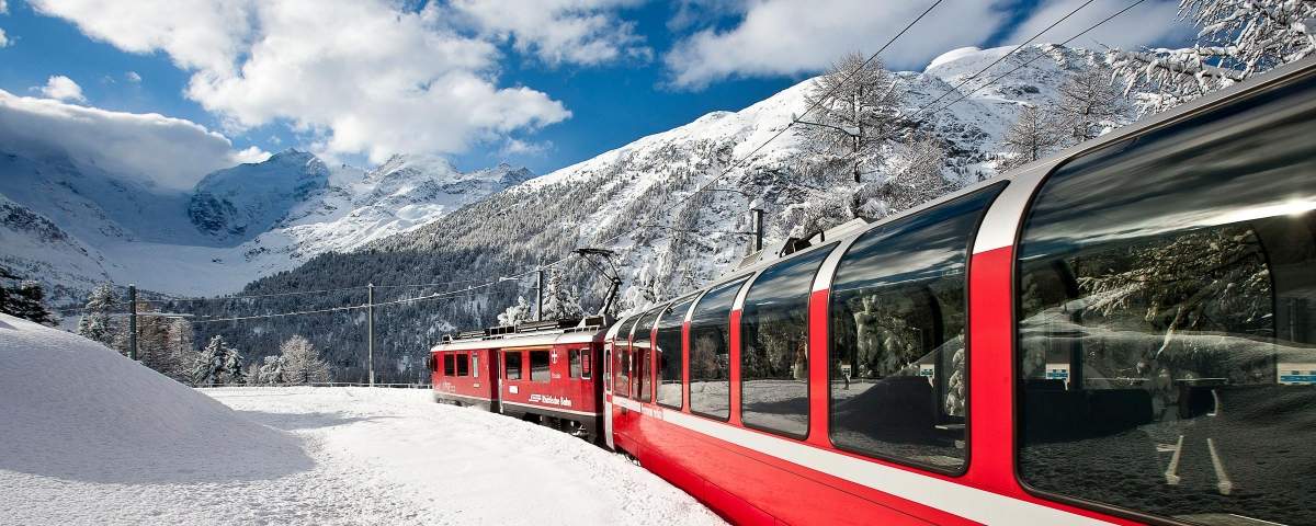 Bernina express in a snow covered landscape in the mountains