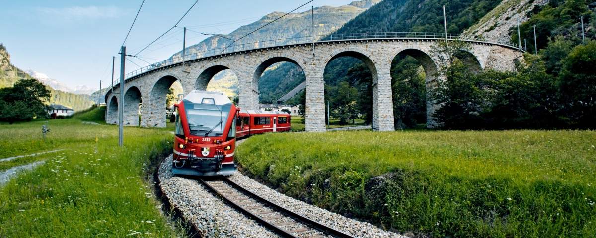 Bernina Express train in front of the viaduct in Brusio