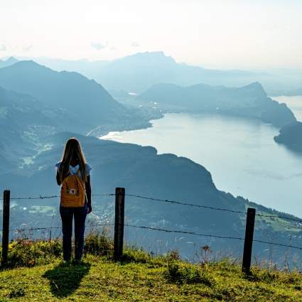 A woman enjoying the view over Lake Lucerne and the mountain range