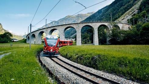 Bernina Express train in front of the viaduct in Brusio