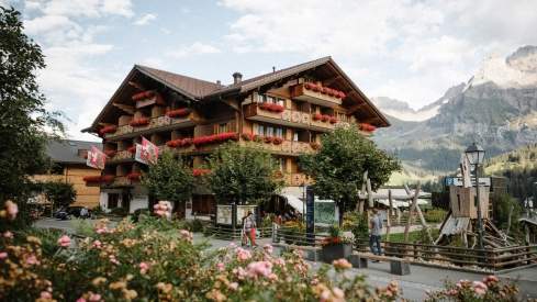 Outside view of Hotel Adler in Adelboden with mountains in the background